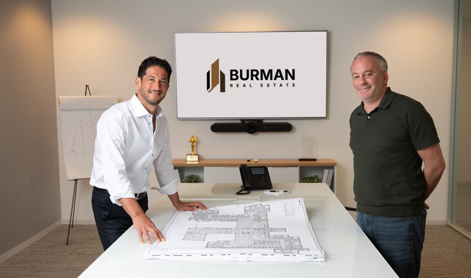 Scott Burman and Adam Mann reviewing plans in the conference room